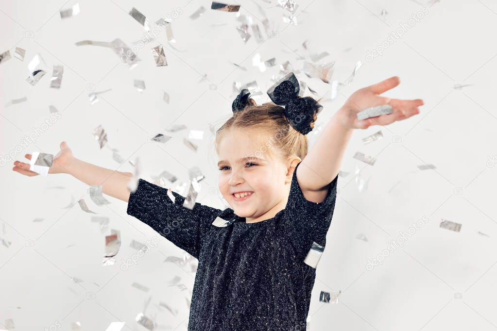 Party, holidays, new year and celebration concept - Female child throwing confetti.