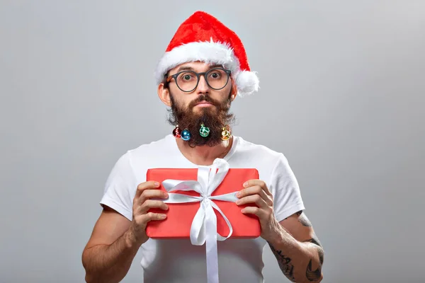 Navidad, vacaciones, barbería y concepto de estilo - joven guapo barbudo santa claus hombre con muchas pequeñas bolas de Navidad en barba larga — Foto de Stock