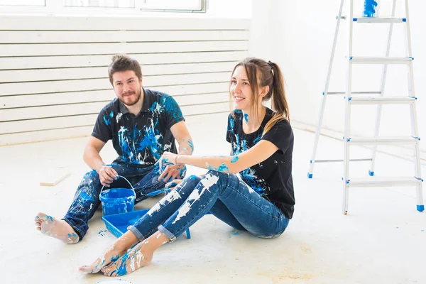 Renovação, redecoração e conceito de família - Casal jovem despeje tinta — Fotografia de Stock