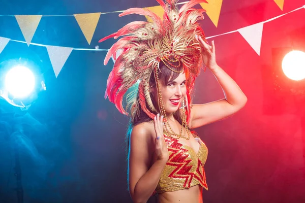 Cabaret, dancer and holidays concept - Cute young girl in bright colorful carnival costume on dark background — Stock Photo, Image