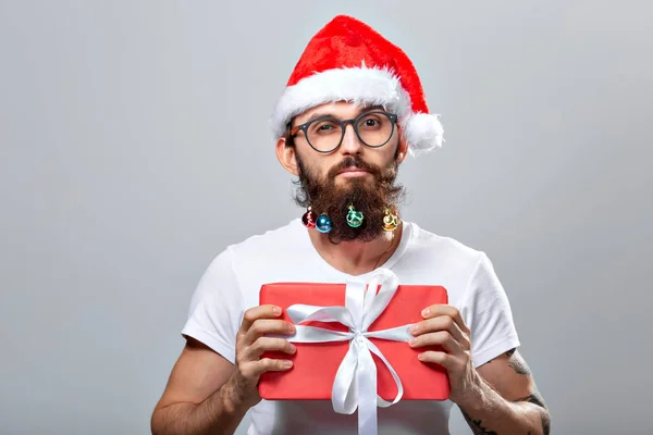 Christmas, holidays, barbershop and style concept - young handsome bearded santa claus man with many small christmas baubles in long beard — Stockfoto