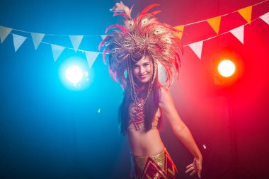 Karnaval, dansçı ve tatil konsepti - Kabare takım elbise güzellik esmer kadın ve doğal tüyler ve rhinestones ile başlık.