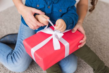 Noel, yalnız ebeveyn ve tatil konsepti - Annesi için Noel hediyesi tutan küçük şirin çocuğun yakın çekimi.