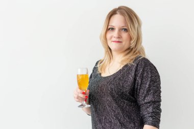 Tatiller, Noel, doğum günü ve yeni yıl konsepti - Kadın beyaz arka planda bir kadehte şarabı kutluyor ve tutuyor