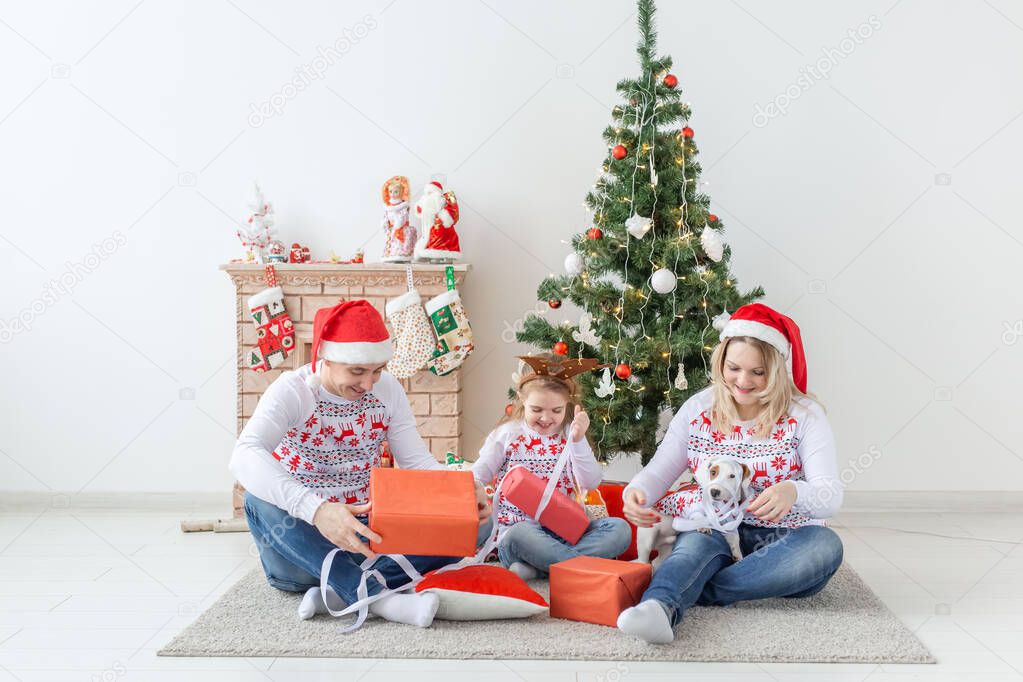 Holidays and presents concept - Portrait of a happy family opening gifts at Christmas time