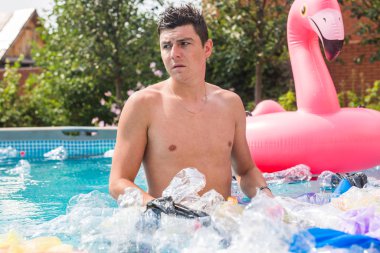 Ekoloji, plastik çöp, çevresel acil durum ve su kirliliği - kirli bir yüzme havuzunda duran şok adam