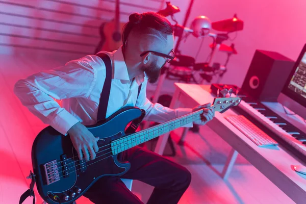 Muziek maken en een opnamestudio concept - Baard man gitarist opnemen elektrische gitaar track in home studio — Stockfoto