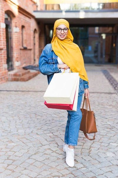 Sale and buying concept - Happy arab muslim girl with shopping bags after mall — Stock Photo, Image