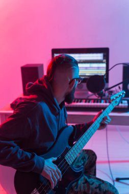 Müzik ve stüdyo konsepti yaratmak - sakallı adam gitarist ev stüdyosunda elektro gitar kaydı yapıyor