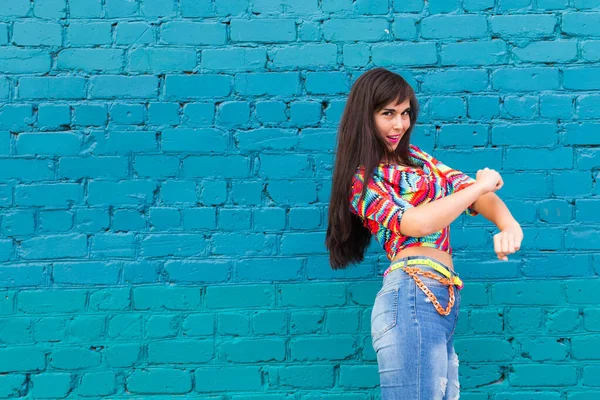 Street dance, freestyle and jazz funk concept - Beautiful girl dancing hip-hop over blue brick wall with copy space