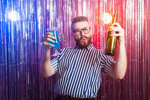 Alcoholism, fun and fool concept - Drunk funny guy at party in a nightclub.