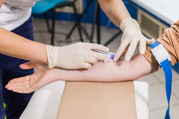 Covid-19, pandemic and viruses concept - Close-up of doctor takes blood on the analysis.