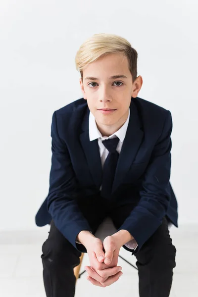 Portrait of stylish school boy teenager in white shirt and jacket against white background. — Stock Photo, Image
