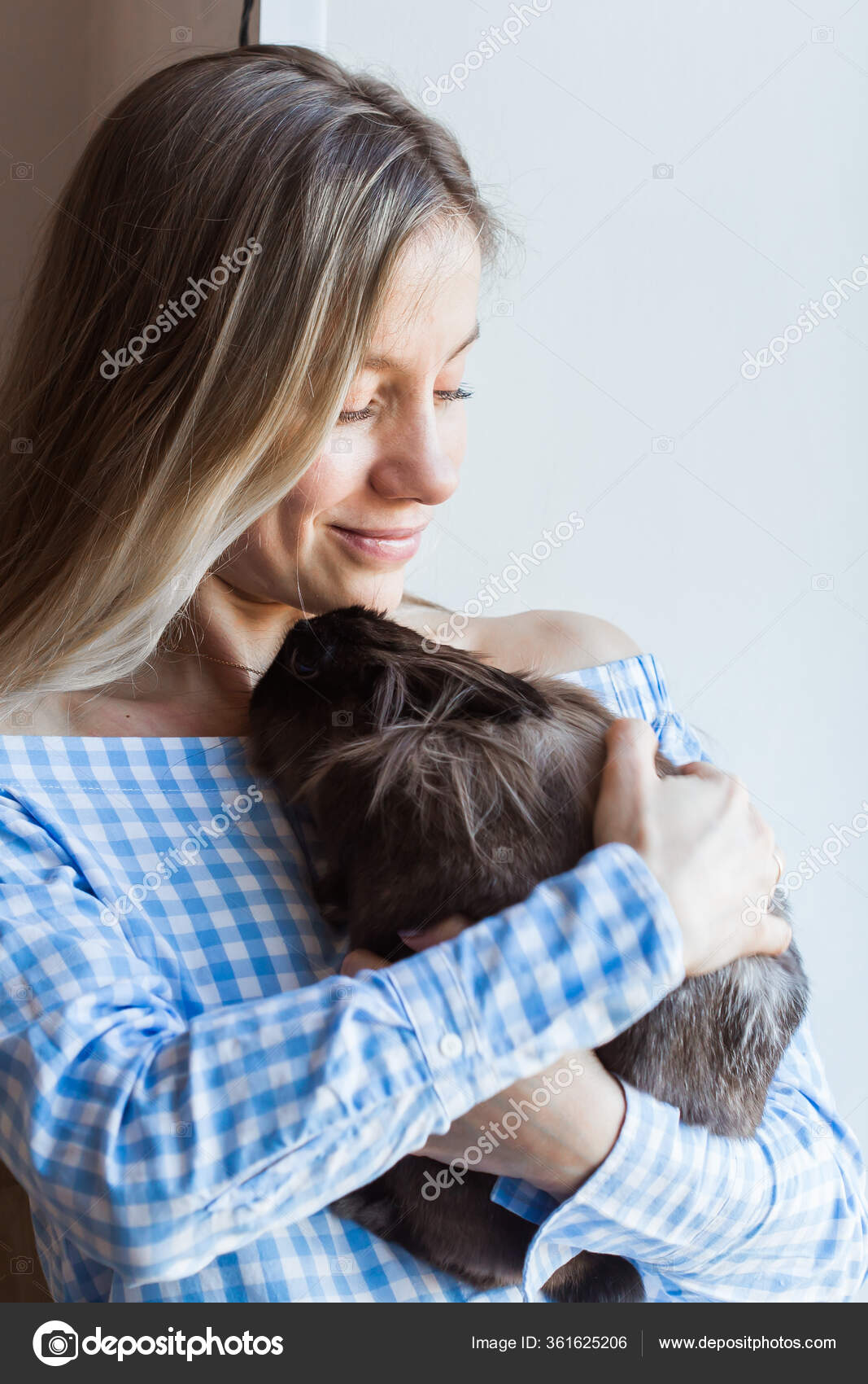 Pet and Easter concept - Happy girl hugging brown rabbit at home ...