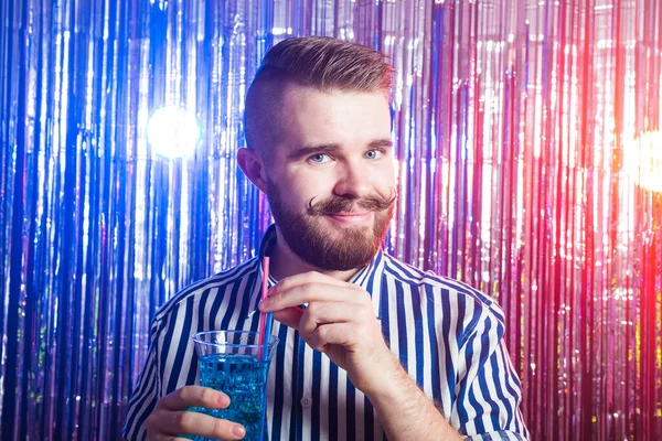 Alcoholism, fun and fool concept - Drunk guy at party in a nightclub.
