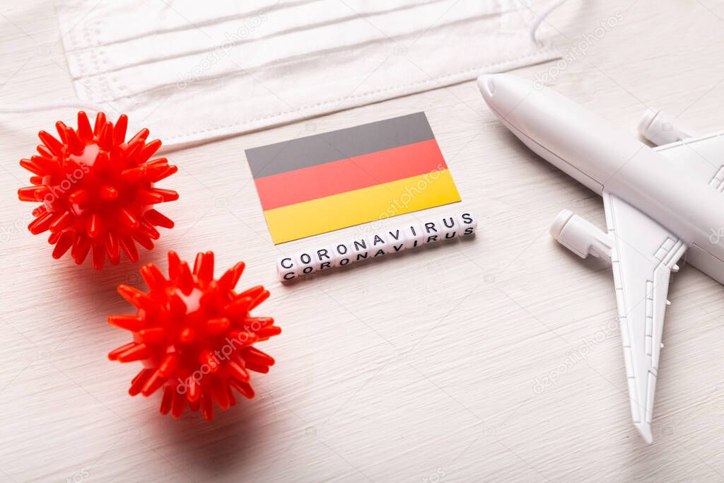 Flight ban and closed borders for tourists and travelers with coronavirus covid-19. Airplane and flag of Germany on a white background. Coronavirus pandemic.