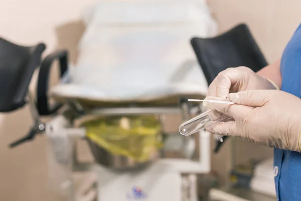 Close-up of doctor hand holds gynecological examination instruments. Gynecologist working in the obstetrics and gynecology department. Medical concept.