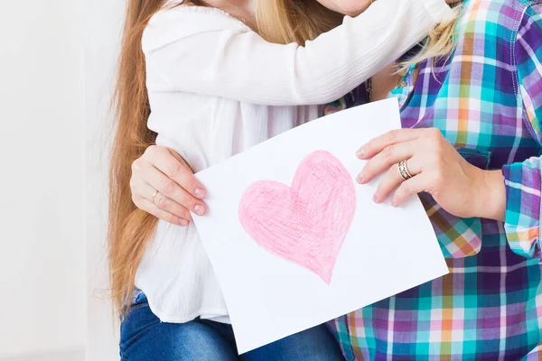 Mothers Day, holidays and family holidays - Mother holds greeting card from her lovely daughter, close-up.