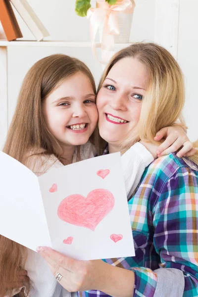 Mothers Day, holidays and family holidays - Mother holds greeting card from her lovely daughter.