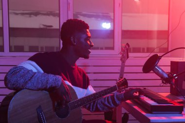 Müzik ve kayıt stüdyosu konsepti yaratmak - Afrikalı Amerikalı gitarist ev stüdyosunda elektro gitar kaydı yapıyor