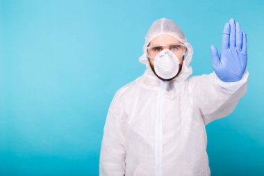 Doktor ya da laboratuvar bilimcisi biyolojik tehlike önleyici giysi giymiş el kol hareketi yaparak Coronavirus COVID-19 hastalığını durduruyor küresel salgın. Giriş yasak, karantina emri. Boşluğu kopyala.