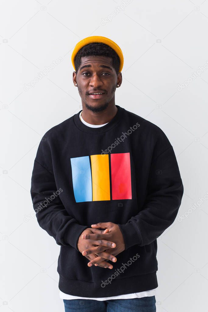 Street fashion concept - Studio shot of young handsome African man wearing sweatshirt against white background.