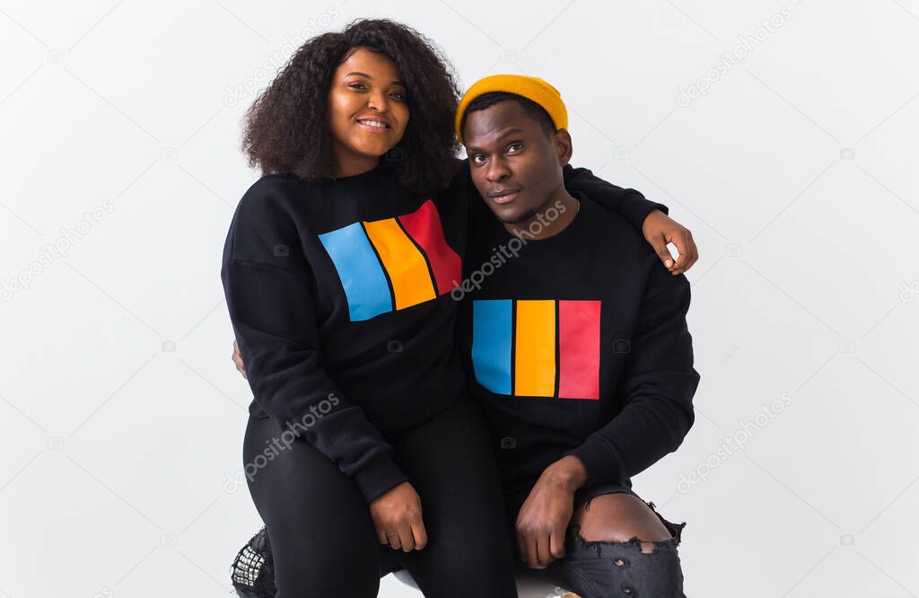 Happy African American woman and man have relationships, toothy smile, happy to meet with friends, dressed casually on white background. Emotions and friendship concept.