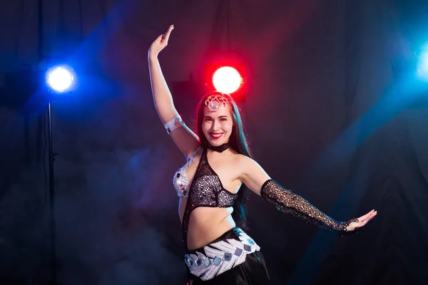 Young woman dancing in Tribal Fusion style. Belly dance on the stage. — Stock Photo, Image