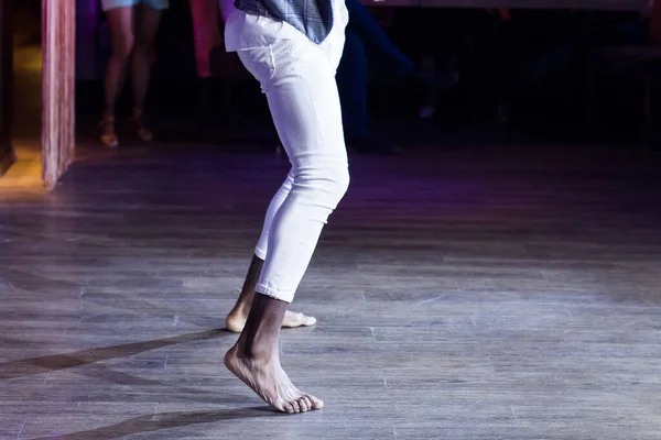 Dancing shoes feet and legs of male ballroom and latin salsa dancer dance teacher on the stage. Social dance, bachata solo and kizomba concept — Stock Photo, Image