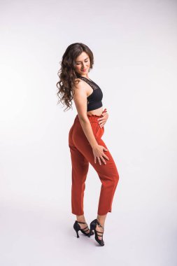 Latin dansı, striptiz dansı, çağdaş ve bachata bayan konsepti - doğaçlama dans eden ve uzun saçlarını beyaz arka planda gezdiren kadın.
