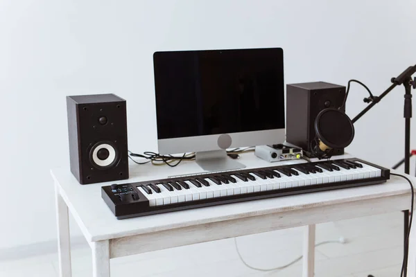 Synthesizer keyboard digital recording and guitars, home music record studio concept. Leisure and hobby concept.