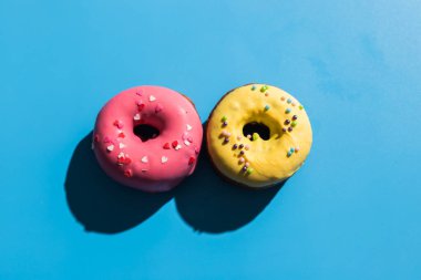 Moda güneş ışığı. Açık mavi turkuaz arka planda yaz çörekleri. Minimum yaz konsepti. Pop sanat tarzı. Çörek.