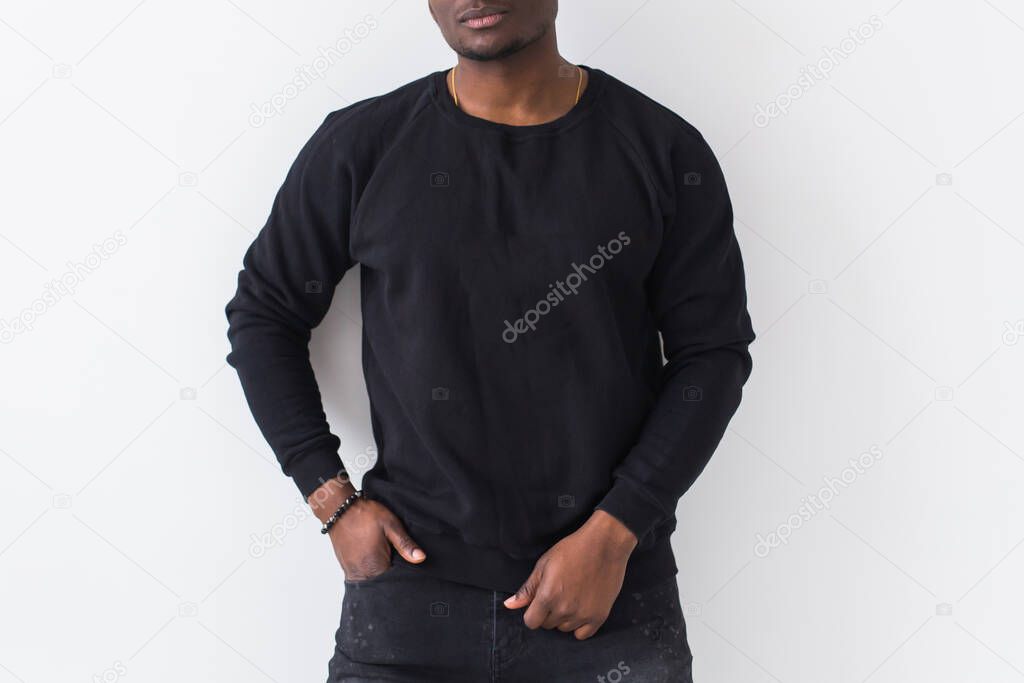 Street fashion concept - Studio shot of young handsome Close-up of African man wearing sweatshirt against white background.