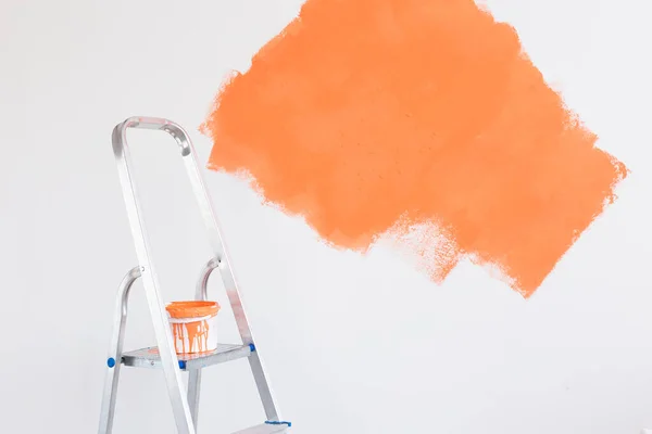 Ladder with paint in bucket near color wall indoors. Renovation and redecoration concept. Copy space. — Stock Photo, Image