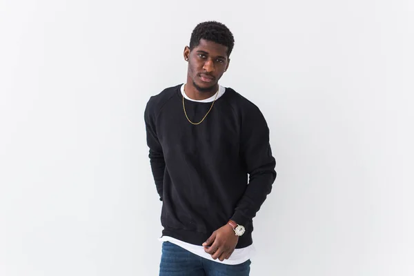 Ifjúsági street fashion koncepció - portré magabiztos szexi fekete férfi elegáns pulóver fehér háttér. — Stock Fotó