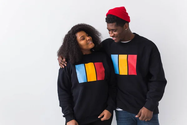 Happy African American woman and man have relationships, toothy smile, happy to meet with friends, dressed casually on white background. Emotions and friendship concept.