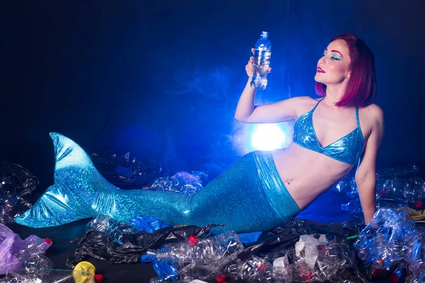 Stupid fairytale mermaid in polluted ocean. Plastic trash and garbage in water. Environmental problem, plastic bag and bottles polluting a coral reef. — Stock Photo, Image