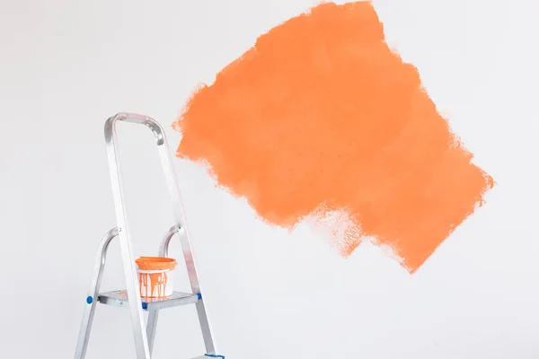 Ladder with paint in bucket near color wall indoors. Renovation and redecoration concept. Copy space. — Stock Photo, Image