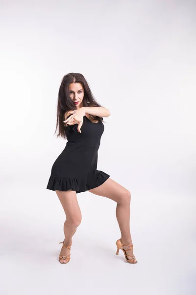 Latina dance, strip dance, contemporary and bachata lady concept - Woman dancing improvisation and moving her long hair on a white background.