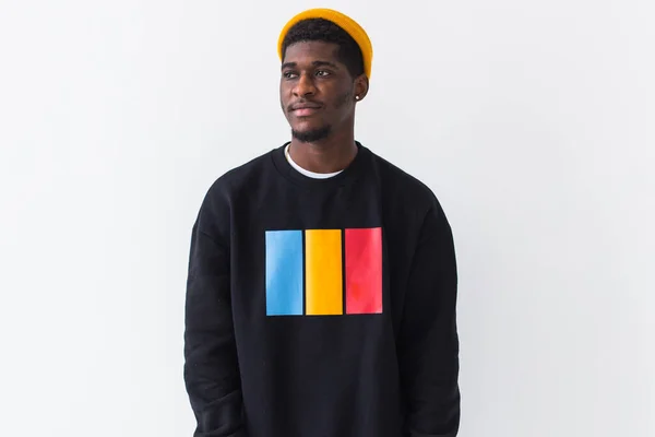 Youth street fashion concept - Portrait of confident sexy black man in stylish sweatshirt on white background. — Stock Photo, Image