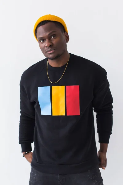 Youth street fashion concept - Portrait of confident sexy black man in stylish sweatshirt on white background. — Stock Photo, Image