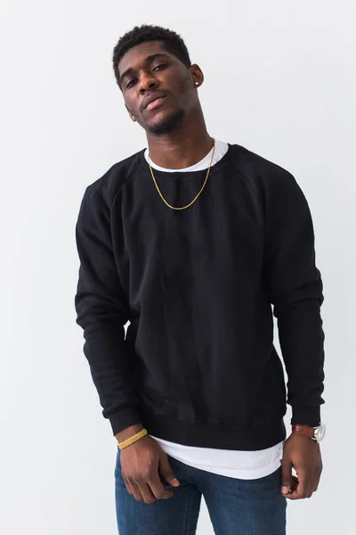 Street fashion concept - Studio shot of young handsome African man wearing sweatshirt against white background. — Stock Photo, Image