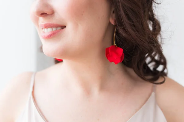 Elegant woman with earrings, close up portrait. Accessories, jewelry and bijouterie concept.