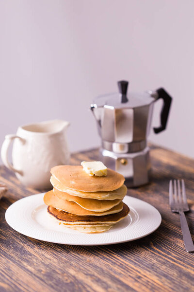 Pile of tasty pancakes with butter. Breakfast concept.