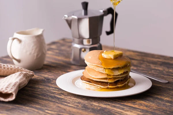 Maple syrup pouring over a stack of mini pancakes. — Stock Photo, Image