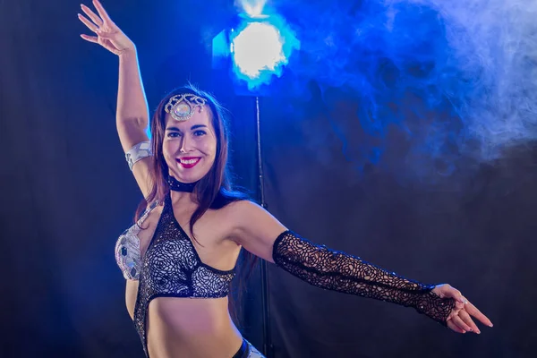 Young woman dancing in Tribal Fusion style. Belly dance on the stage. — Stock Photo, Image