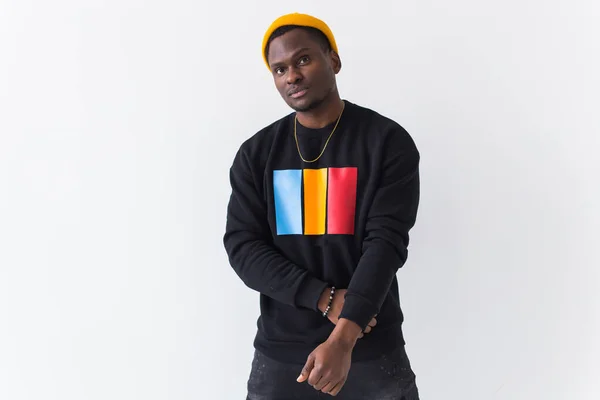 Handsome African American man posing in black sweatshirt on a white background with copyspace. Youth street fashion photo with afro hairstyle. — Stock Photo, Image