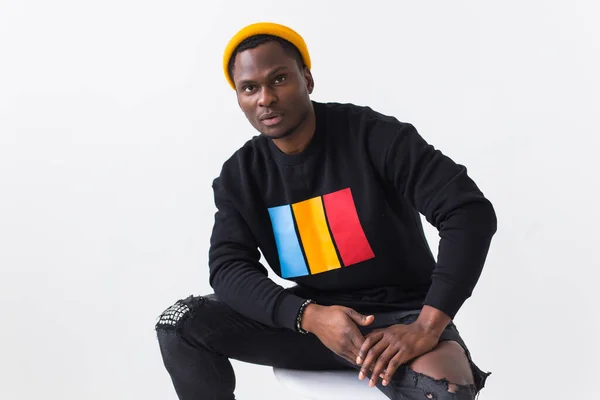 Street fashion concept - Studio shot of young handsome African man wearing sweatshirt against white background. — Stock Photo, Image