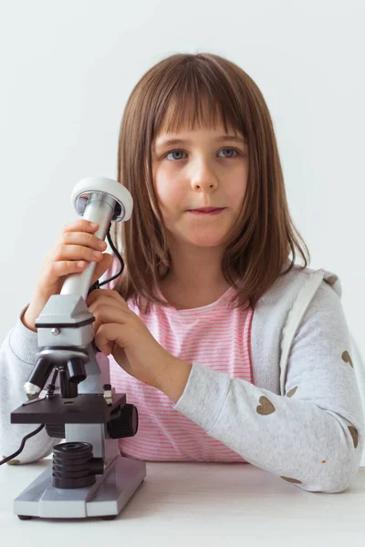Niña en clase de ciencias usando microscopio digital. Tecnologías, niños y concepto de aprendizaje . — Foto de Stock
