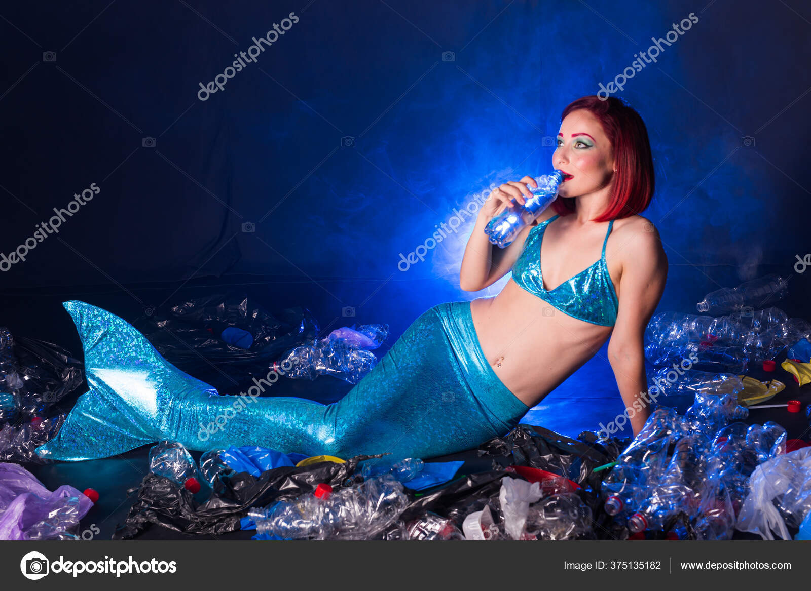 Fantasy stupid mermaid in deep ocean. Plastic water bottles and